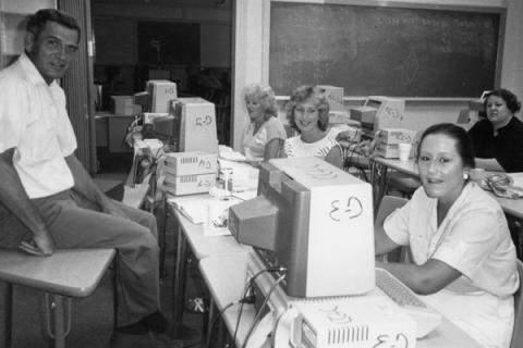 Historical image of students working with early computers